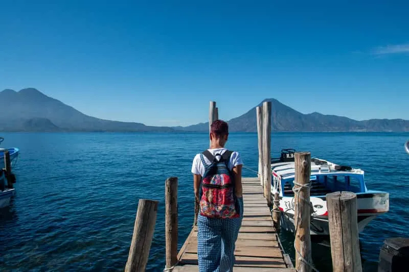 Small group travelers at a Mayan artisan workshop in a Lake Atitlán village after arriving by lancha from Panajachel, cultural boat tour